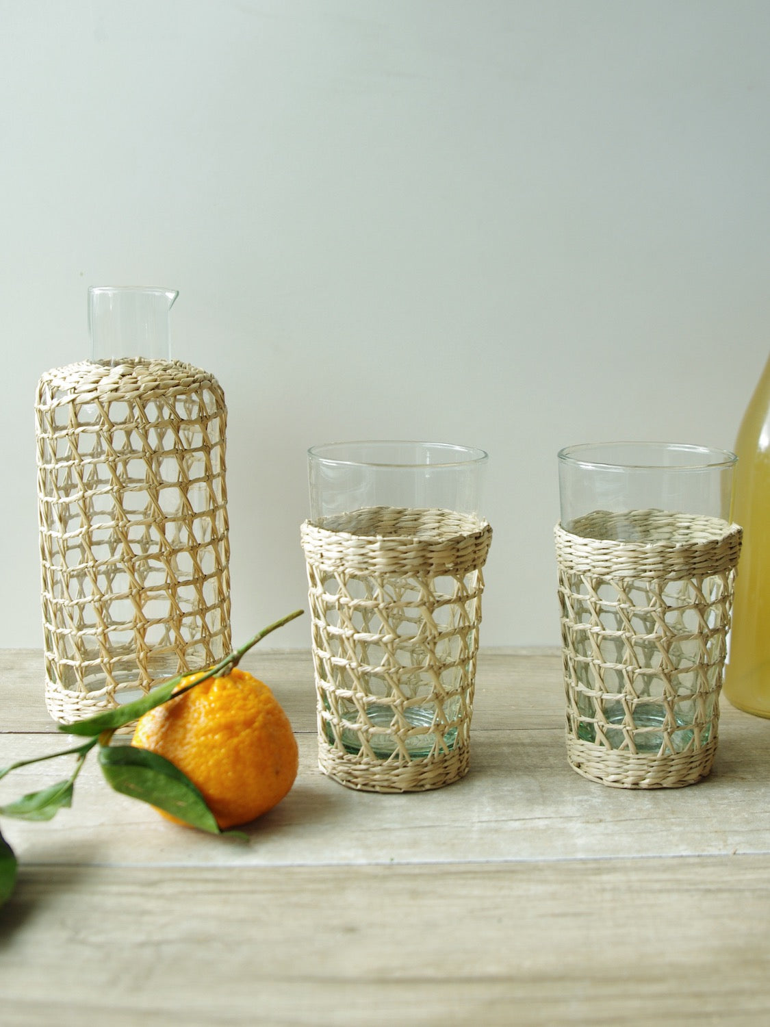 Seagrass Large Cage Carafe Glass Seagrass Brand_Seagrass & Rattan Carafes Kitchen_Drinkware Serving Pieces SeagrassWrappedCarafeandHighballGlasses_1125x1500_c518237a-599c-4253-a456-0c678b6d779a