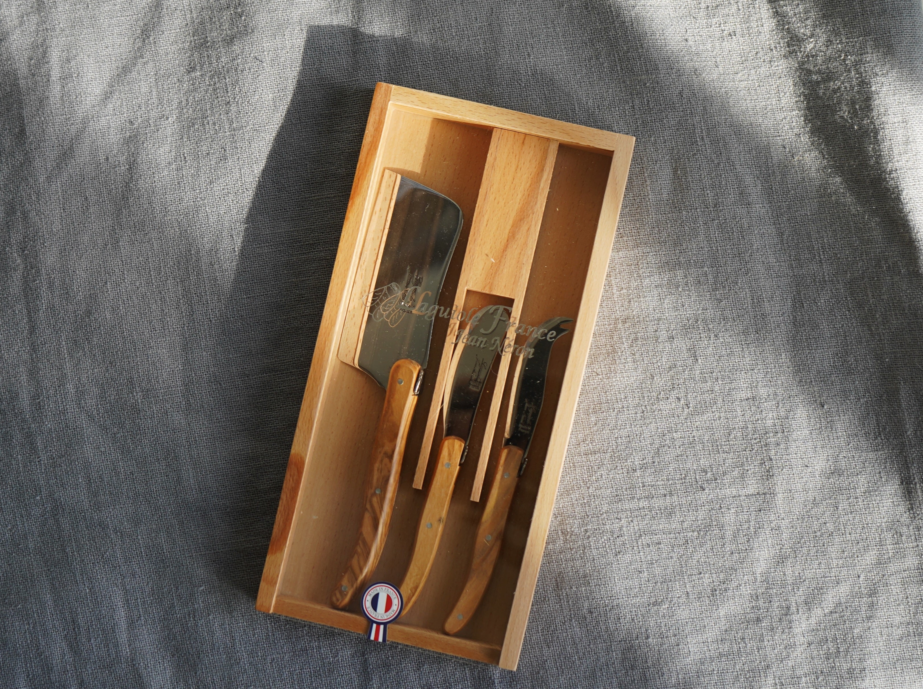 Laguiole Olivewood Large Cheese Set in Wood Box with Acrylic Lid (Set of 3) Cutlery Set Laguiole Brand_Laguiole Kitchen_Dinnerware Kitchen_Serveware Knife Sets Laguiole New Arrivals Spring Collection 4551BC25-ED08-49A3-8962-C5F5C6EB36E5